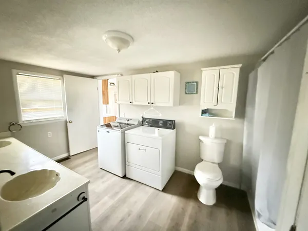a view of a kitchen with wooden floor and a sink