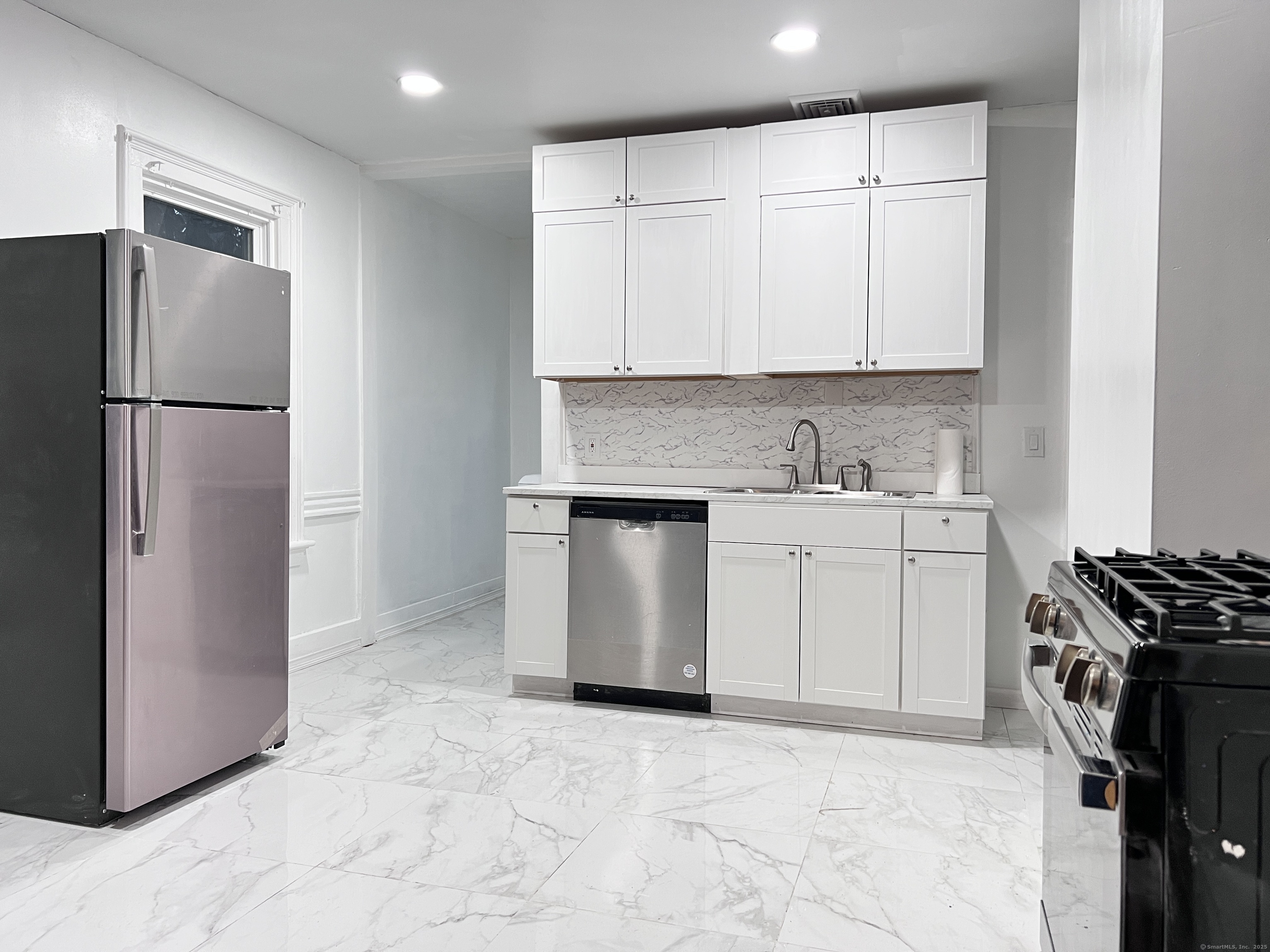 40 Exchange Street, Unit 2 New Haven, CT 06513 - Photo 2 of 12 a kitchen with white cabinets and refrigerator