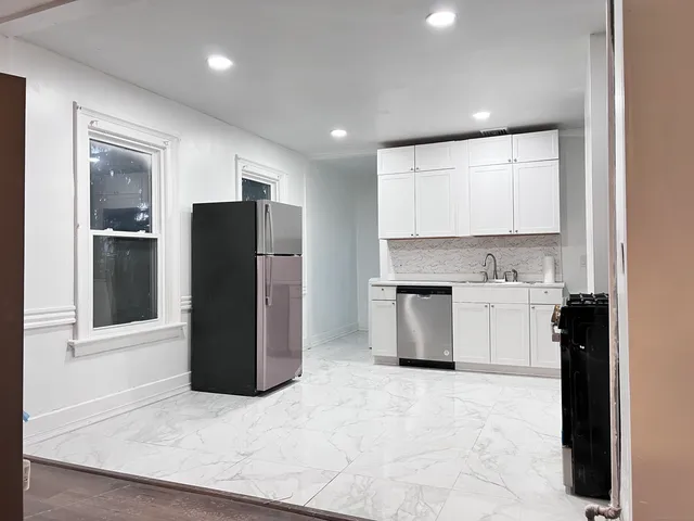 a kitchen with a refrigerator and a sink