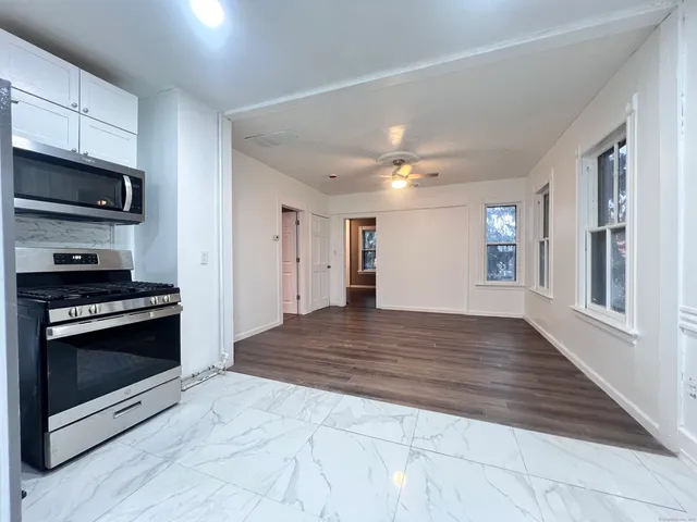 a view of kitchen stove microwave and cabinets