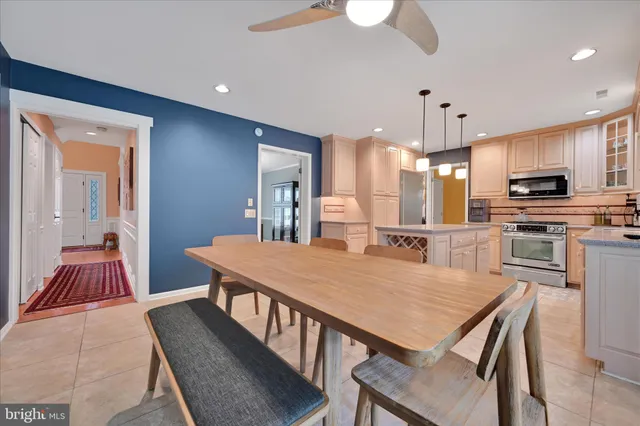 a large kitchen with a table and chairs