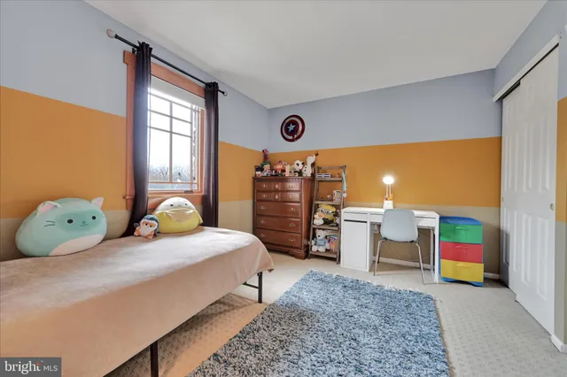 a bedroom with a bed and a flat tv screen