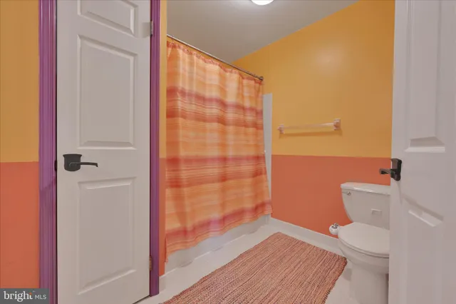 a bedroom with furniture and a lamp