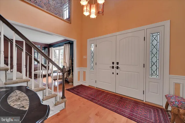 a view of a hallway with entryway wooden floor and front door