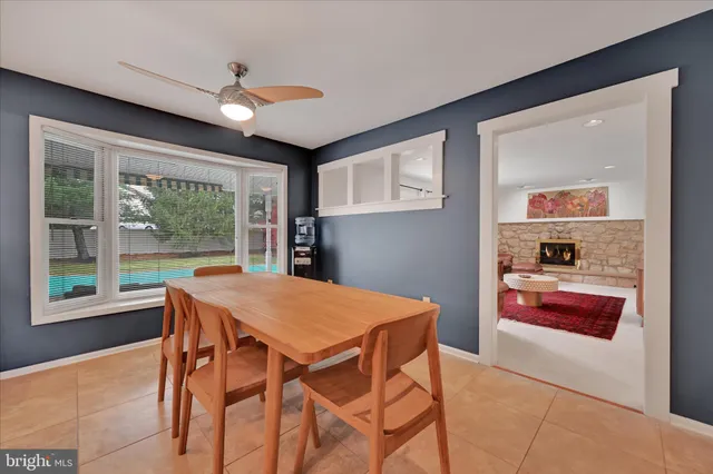 a dining room with a large window and table