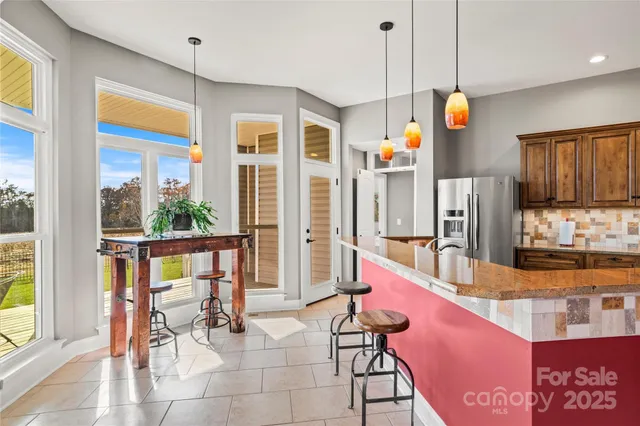 a very nice looking kitchen with a large window cabinets and stainless steel appliances