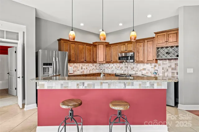 a kitchen with kitchen island granite countertop wooden cabinets and a sink