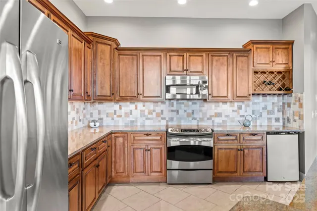 a kitchen with stainless steel appliances a stove and a refrigerator
