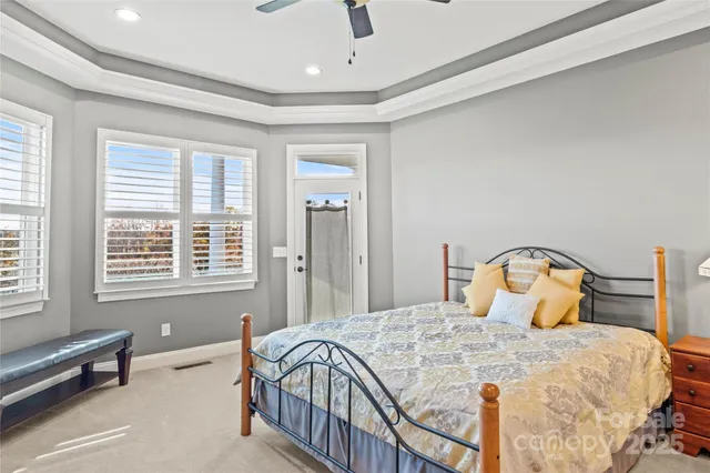 a bedroom with a bed a table and window