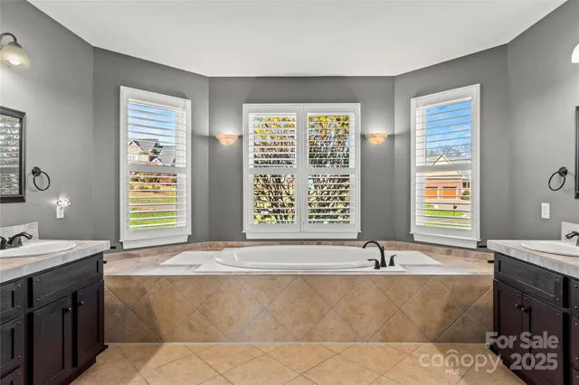 a bath tub sitting in a bathroom next to a window