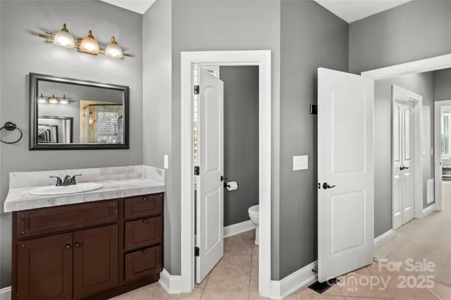 a bathroom with double vanity sinks and a mirror