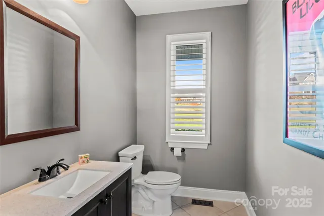 a bathroom with a sink a toilet and a window