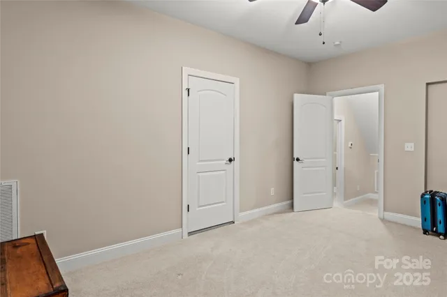 a view of a livingroom with a chandelier fan