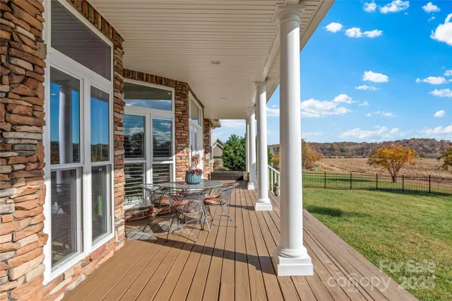 a view of a balcony with floor to ceiling windows with wooden floor