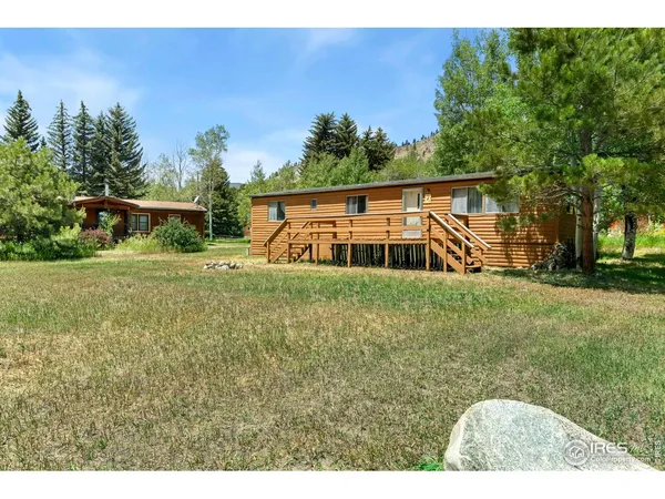 a house with green field in front of it
