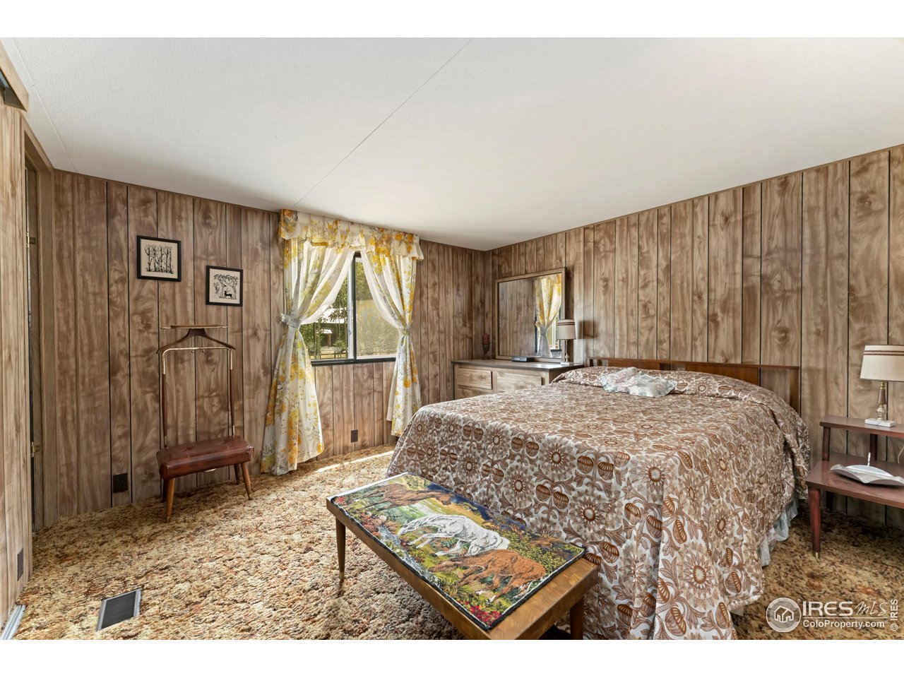 277 Riverside Drive Bellvue, CO 80512 - Photo 13 of 23 a bedroom with a bed and a window