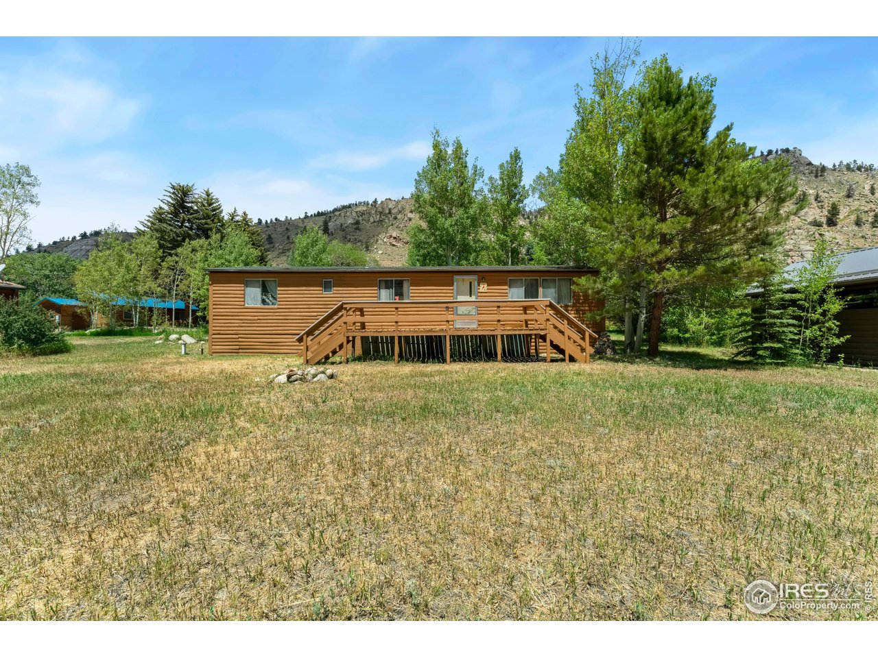 277 Riverside Drive Bellvue, CO 80512 - Photo 2 of 23 a view of a house with a yard