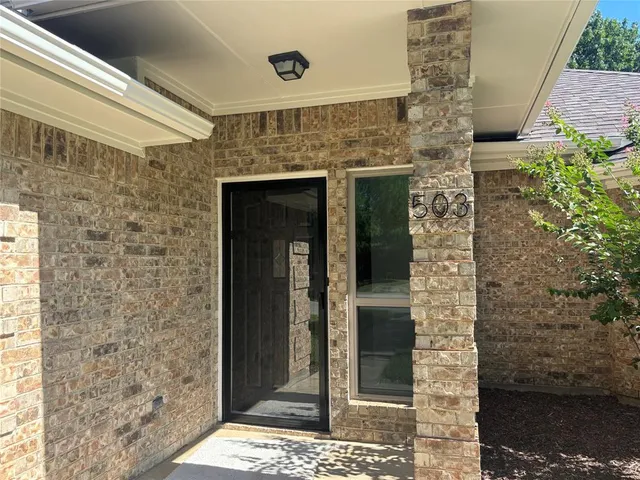 a brick building with a door and a shower