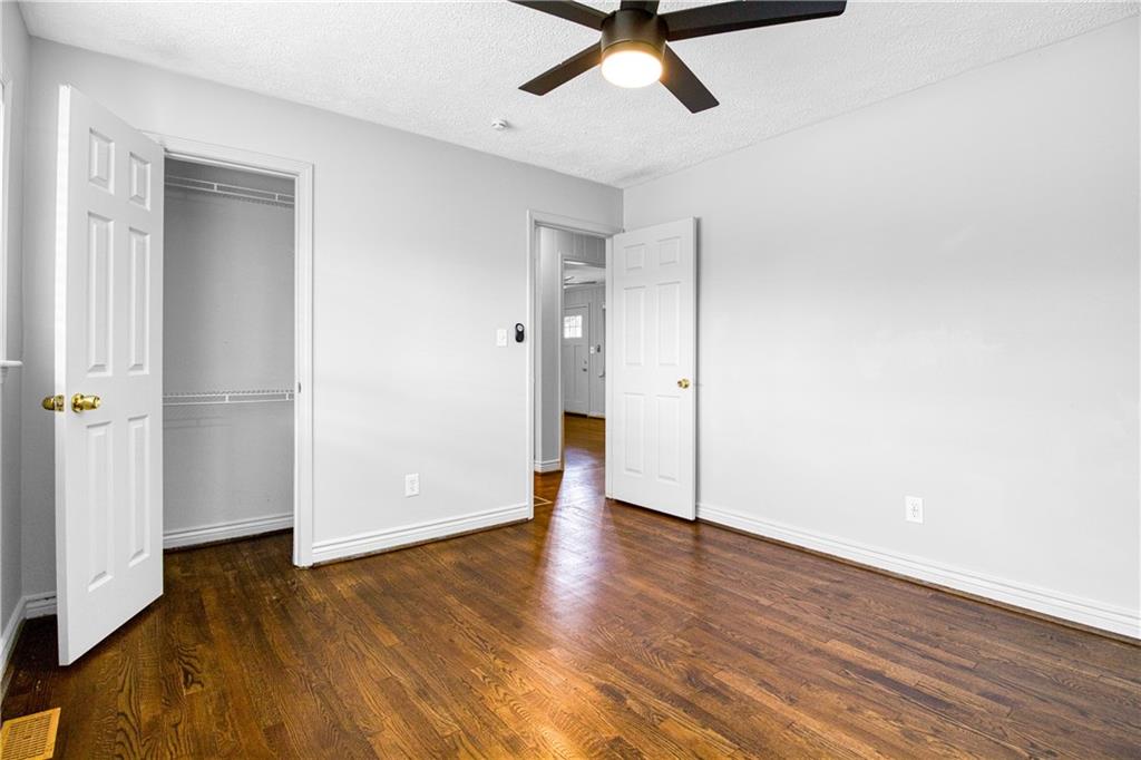 3447 Pierce Street Atlanta, GA 30337 - Photo 13 of 28 an empty room with wooden floor and windows