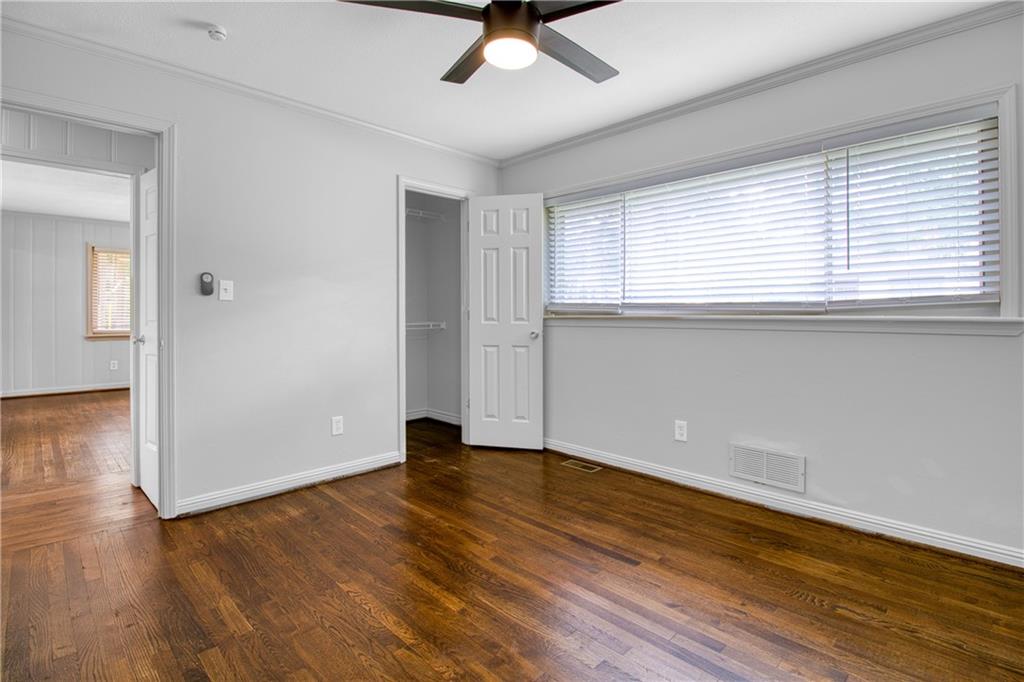 3447 Pierce Street Atlanta, GA 30337 - Photo 15 of 28 an empty room with wooden floor and windows