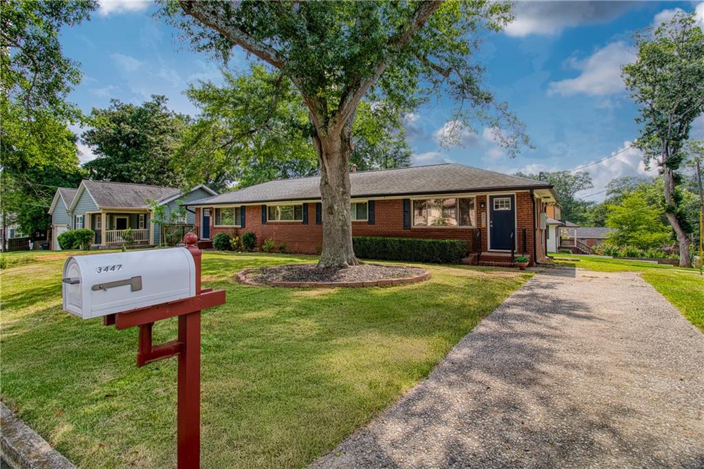 3447 Pierce Street Atlanta, GA 30337 - Photo 2 of 28 a front view of a house with a yard table and chairs