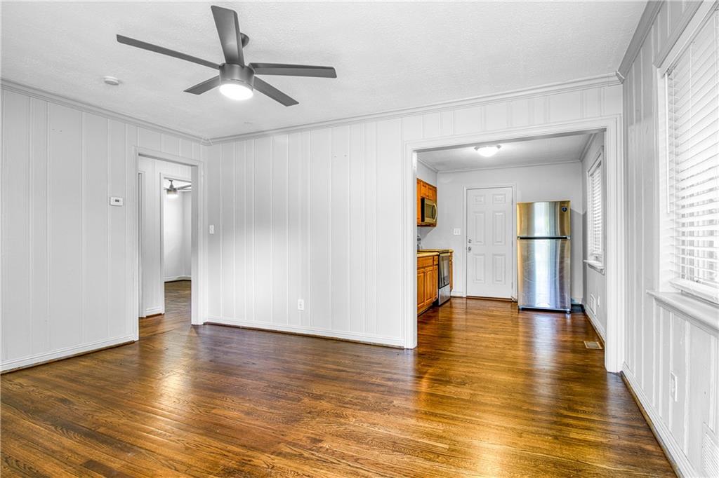3447 Pierce Street Atlanta, GA 30337 - Photo 6 of 28 an empty room with wooden floor and windows