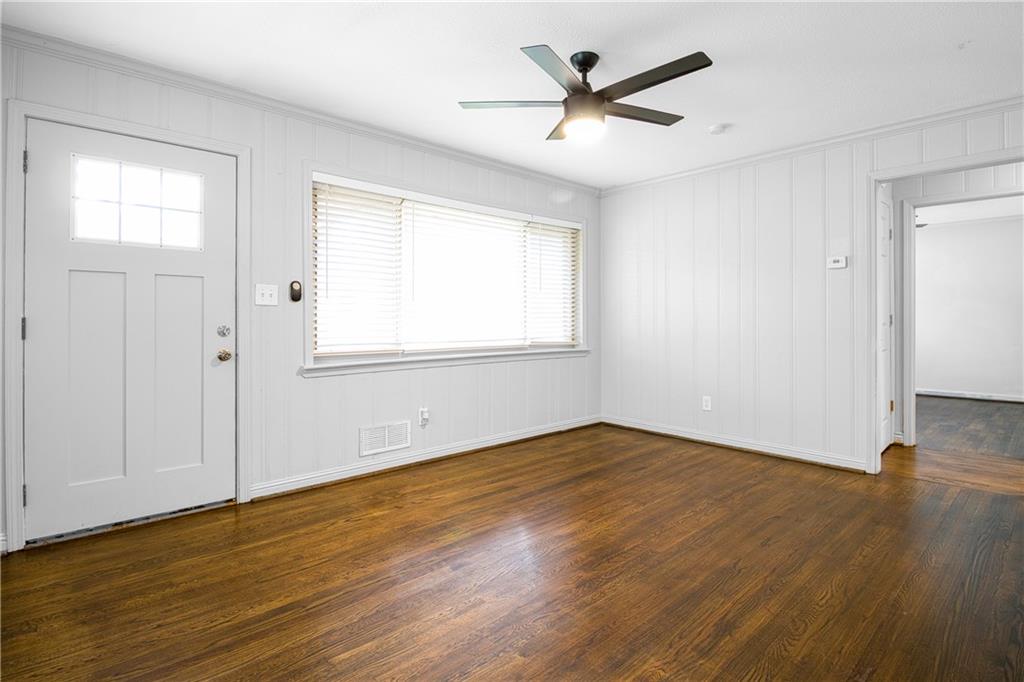 3447 Pierce Street Atlanta, GA 30337 - Photo 7 of 28 an empty room with wooden floor and windows