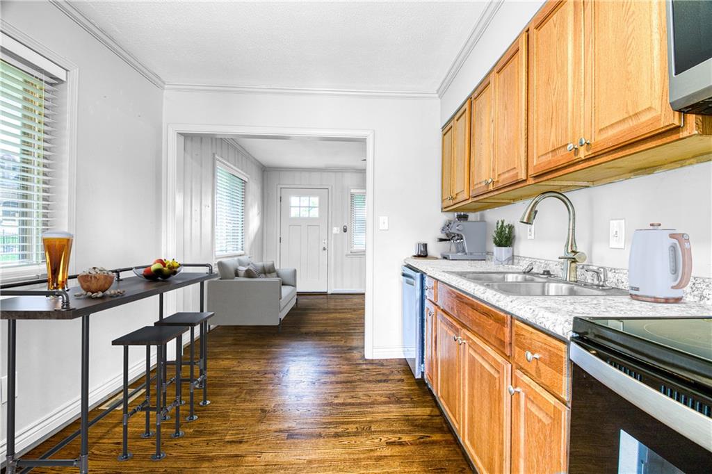 3447 Pierce Street Atlanta, GA 30337 - Photo 10 of 28 a kitchen with stainless steel appliances granite countertop a sink stove and cabinets