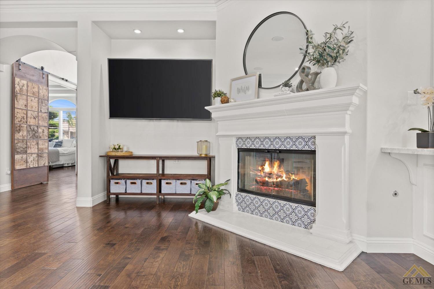 Undisclosed Address Bakersfield, CA 93311 - Photo 15 of 45 a living room with furniture a flat screen tv and a fireplace