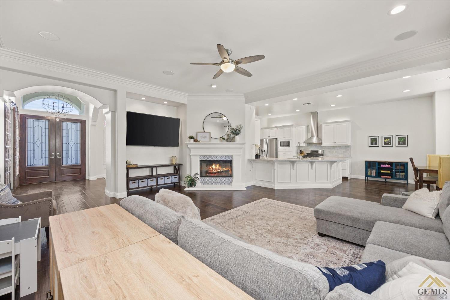 Undisclosed Address Bakersfield, CA 93311 - Photo 16 of 45 a living room with furniture a fireplace and a flat screen tv