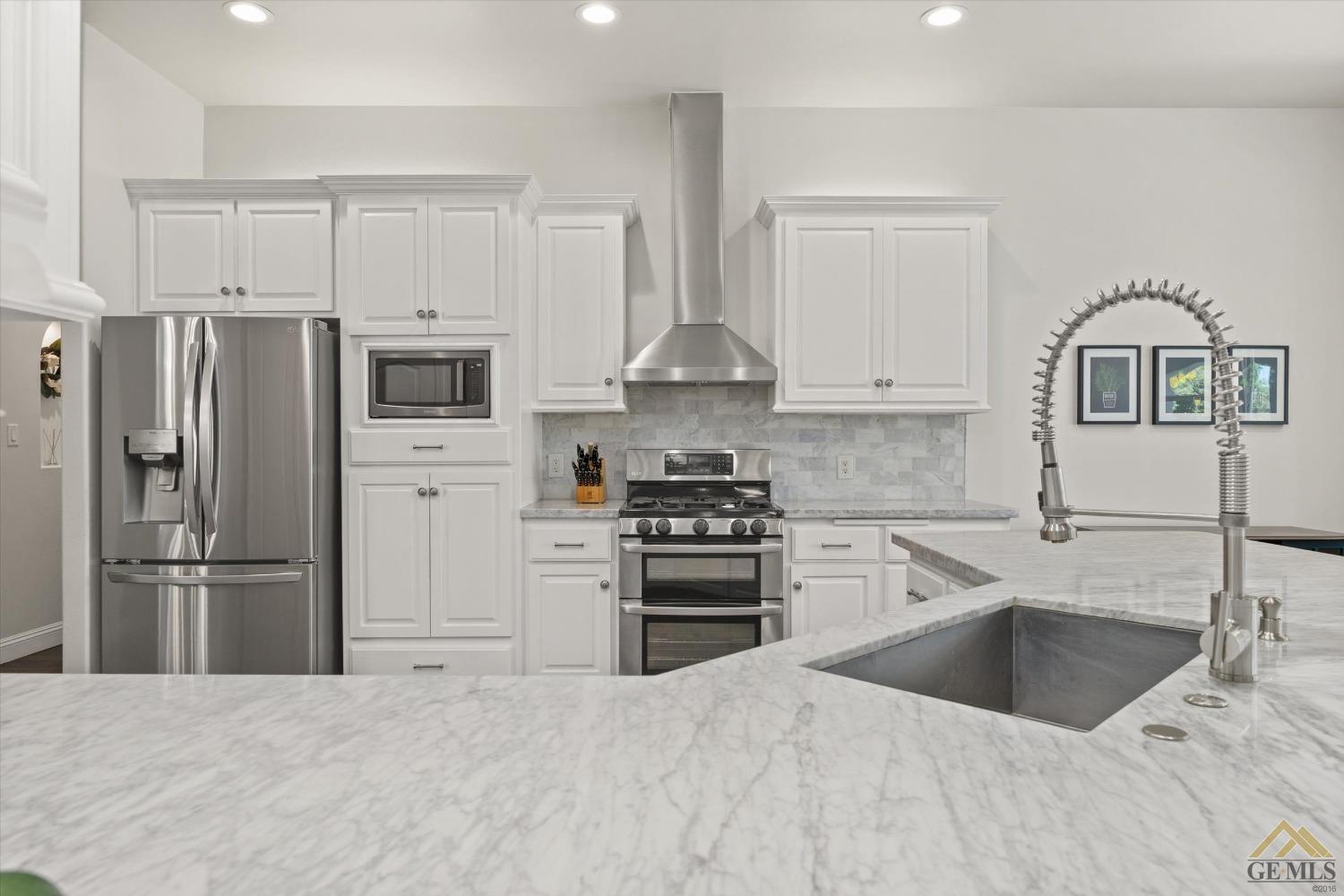 Undisclosed Address Bakersfield, CA 93311 - Photo 19 of 45 a kitchen with granite countertop a refrigerator stove and sink