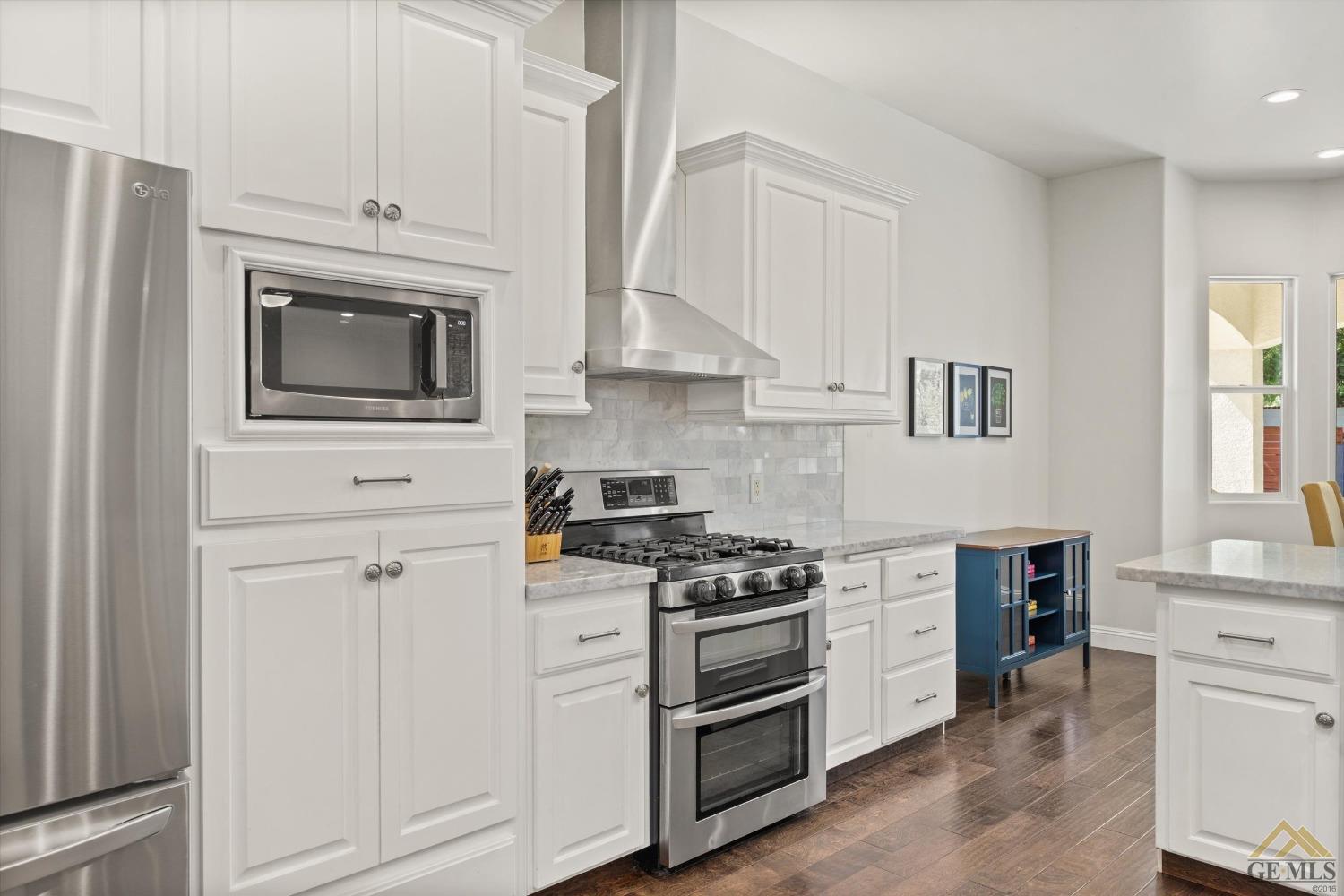 Undisclosed Address Bakersfield, CA 93311 - Photo 21 of 45 a kitchen with stainless steel appliances white cabinets and stove