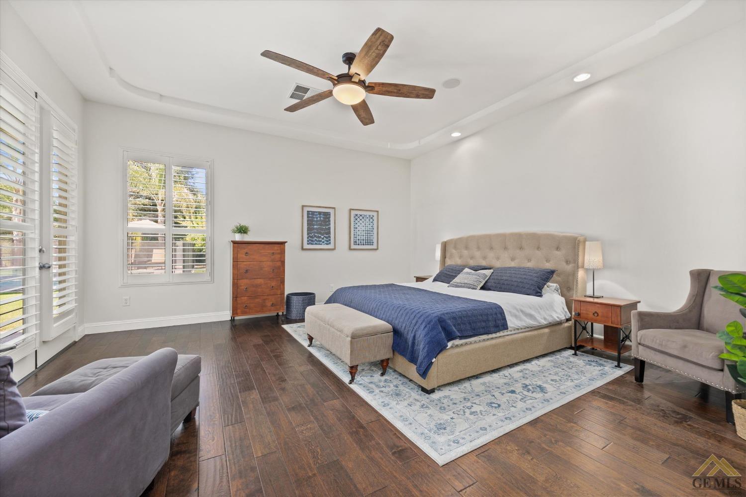 Undisclosed Address Bakersfield, CA 93311 - Photo 24 of 45 a bedroom with a large bed couch and windows