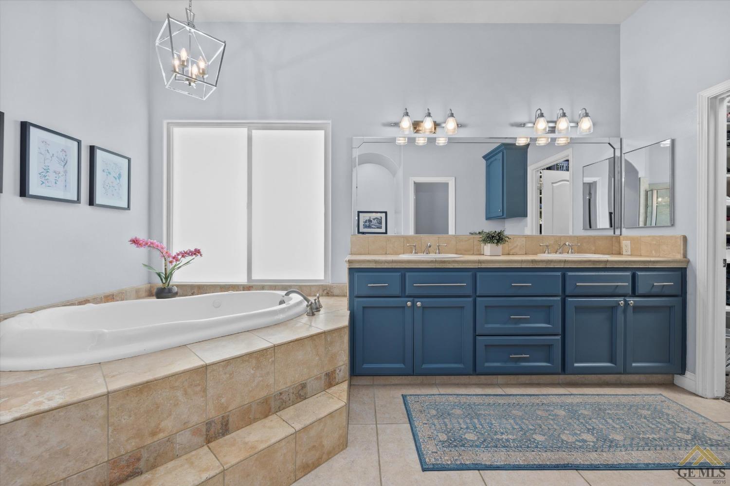 Undisclosed Address Bakersfield, CA 93311 - Photo 26 of 45 a spacious bathroom with a granite countertop sink and a mirror