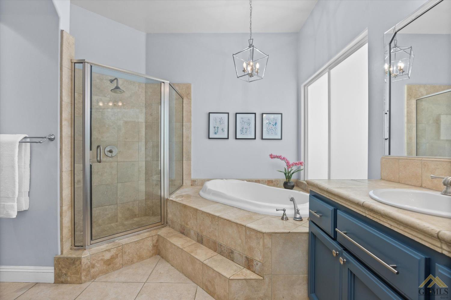 Undisclosed Address Bakersfield, CA 93311 - Photo 27 of 45 a bathroom with a granite countertop sink a toilet a mirror and shower