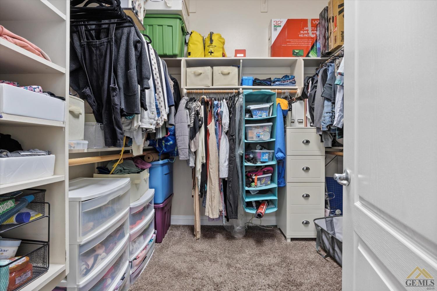 Undisclosed Address Bakersfield, CA 93311 - Photo 29 of 45 a view of walk in closet with clothes and shoes