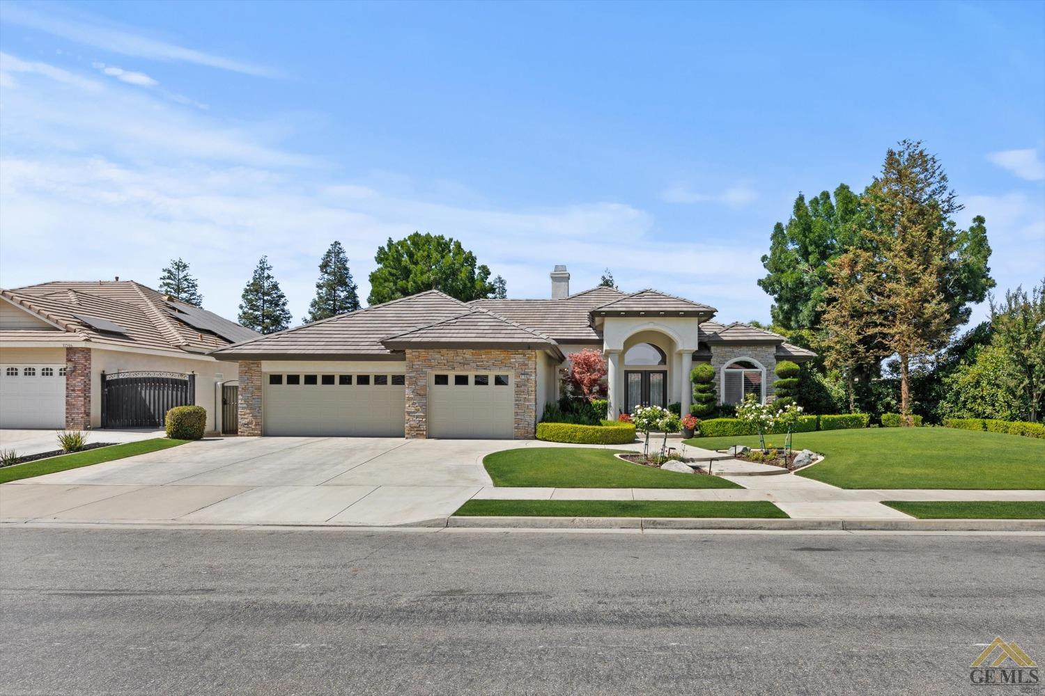 Undisclosed Address Bakersfield, CA 93311 - Photo 3 of 45 a view of a house with a yard and large trees