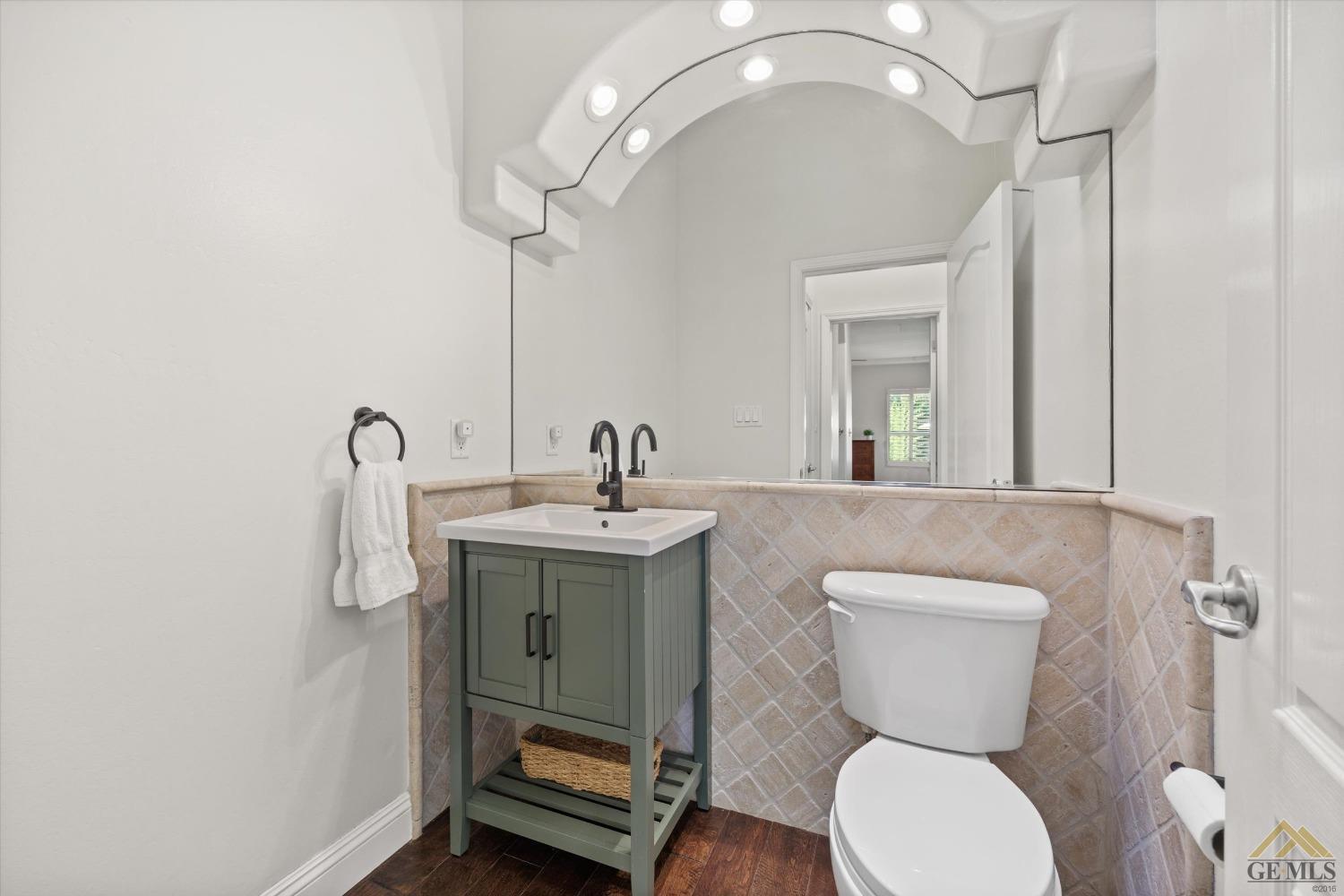 Undisclosed Address Bakersfield, CA 93311 - Photo 34 of 45 a bathroom with a toilet sink and mirror