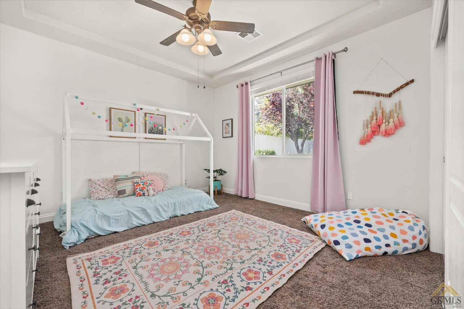 Undisclosed Address Bakersfield, CA 93311 - Photo 35 of 45 a bedroom with a bed and a chandelier