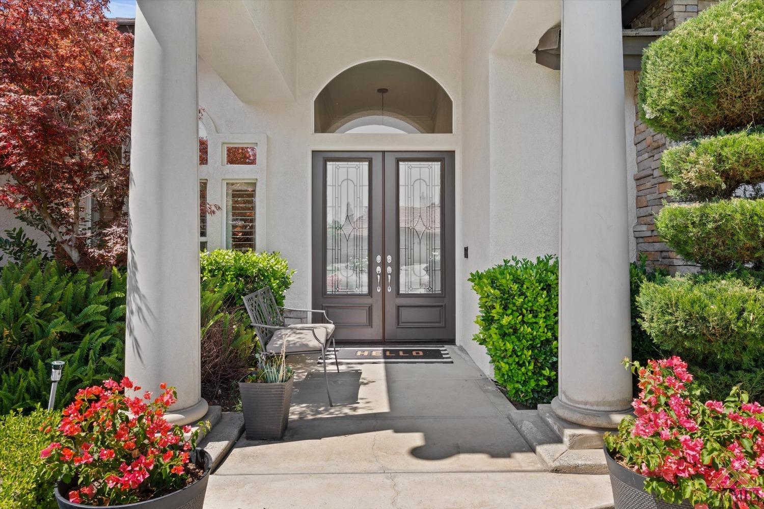 Undisclosed Address Bakersfield, CA 93311 - Photo 5 of 45 a front view of a house with a yard and flowers
