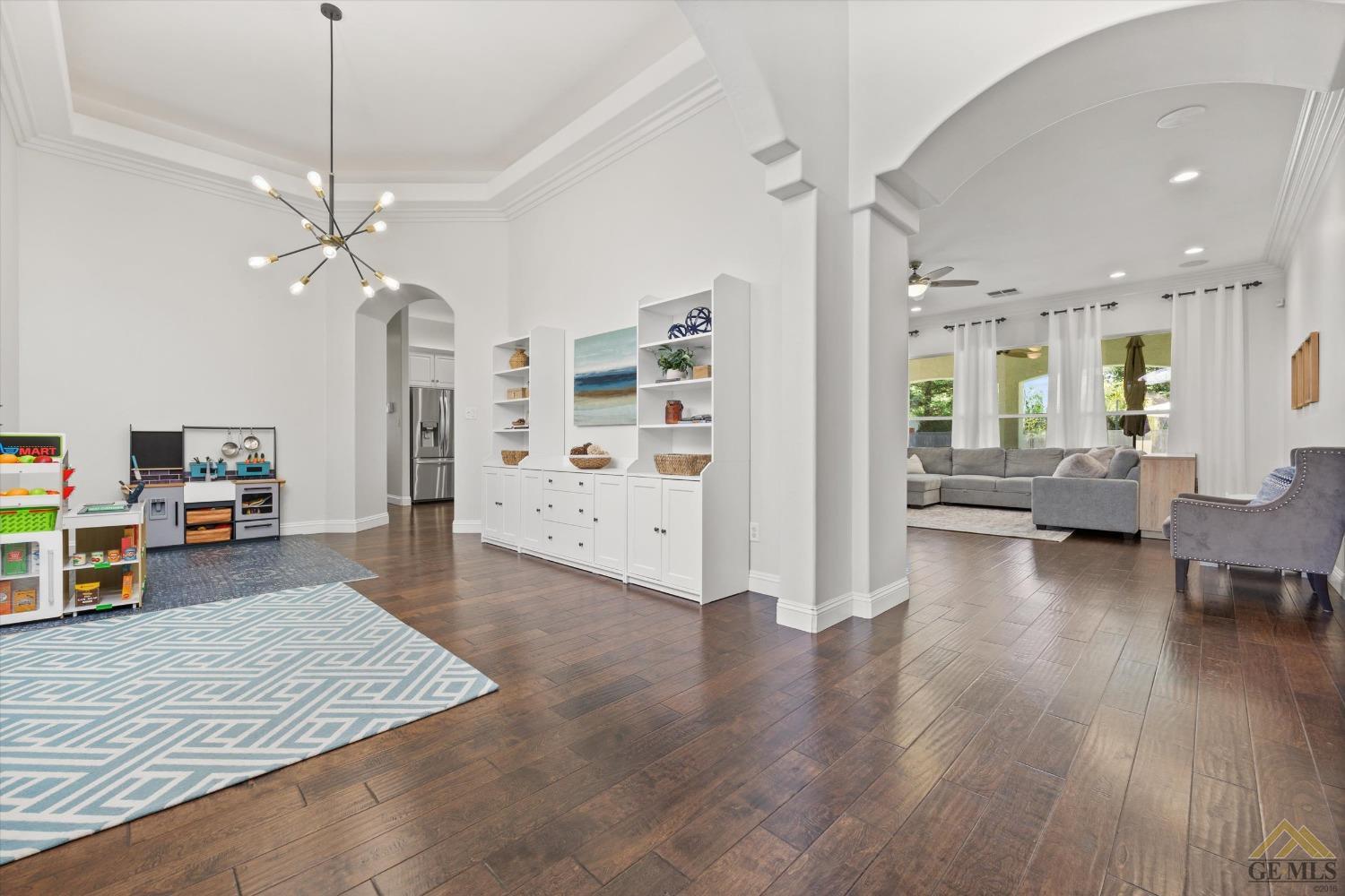 Undisclosed Address Bakersfield, CA 93311 - Photo 8 of 45 a living room with furniture and a wooden floor