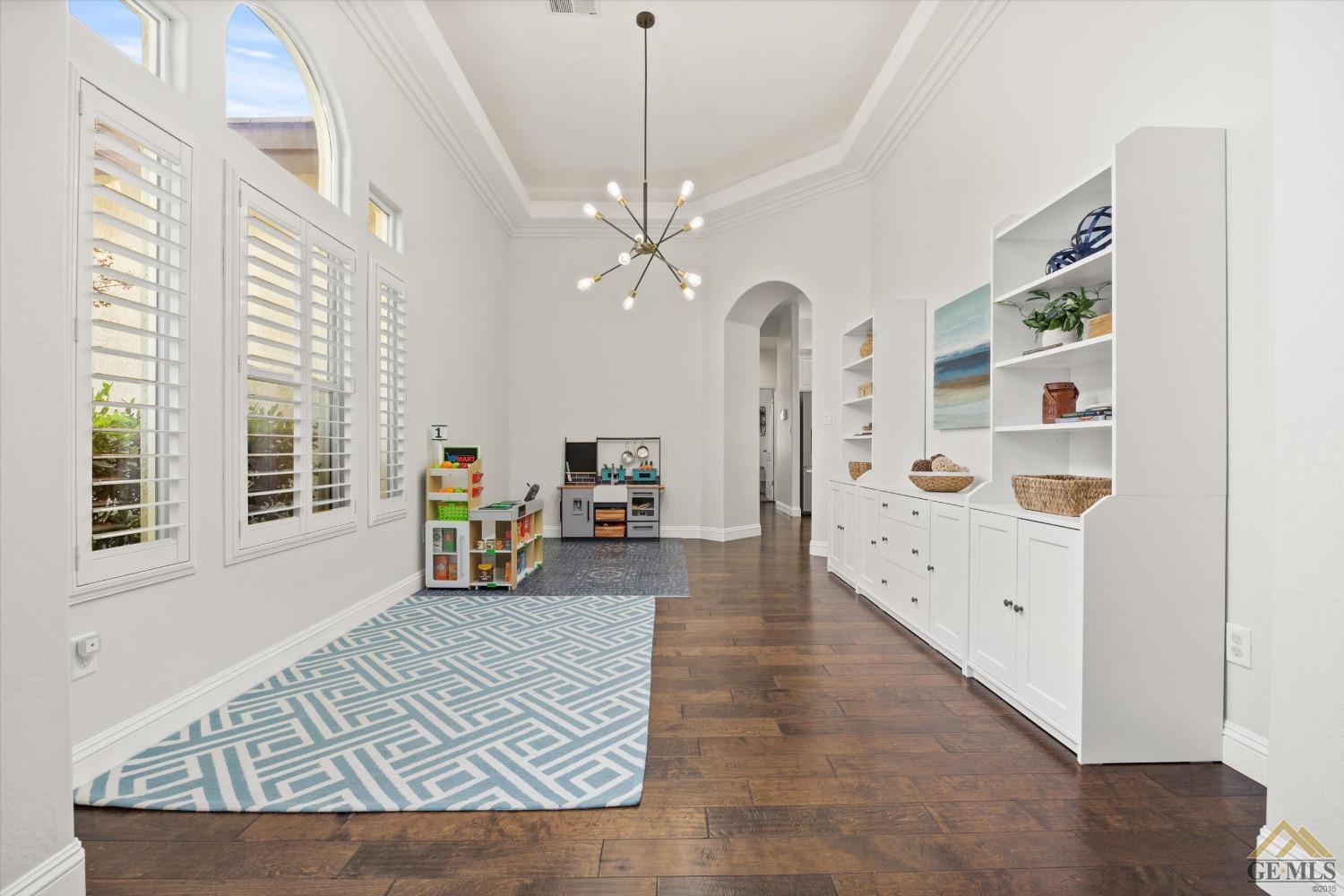 Undisclosed Address Bakersfield, CA 93311 - Photo 9 of 45 a living room with furniture and a chandelier