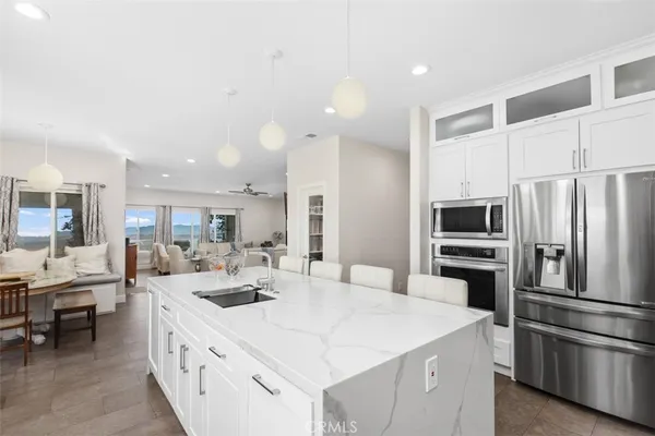 a kitchen with kitchen island a sink appliances and cabinets