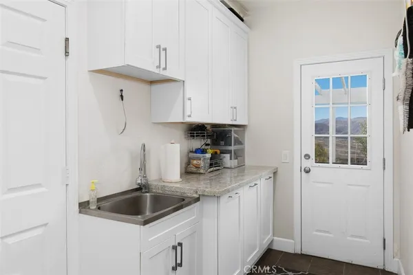 a kitchen with granite countertop a sink and cabinets