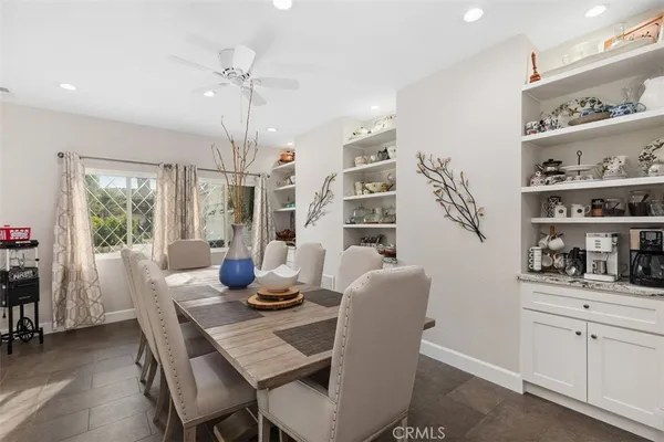 a dining room with furniture and window