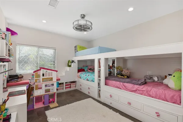 a bedroom with a bed and large window