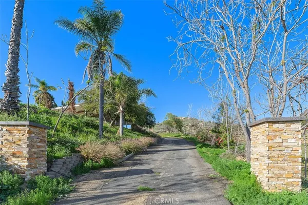 a view of a backyard with a small deck and a garden