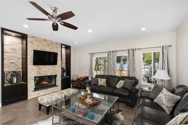 a living room with furniture fireplace and a flat screen tv