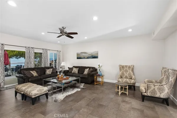 a living room with furniture and a ceiling fan