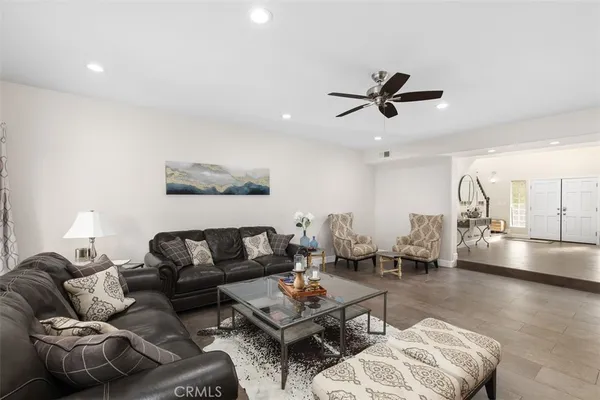 a living room with furniture and kitchen view